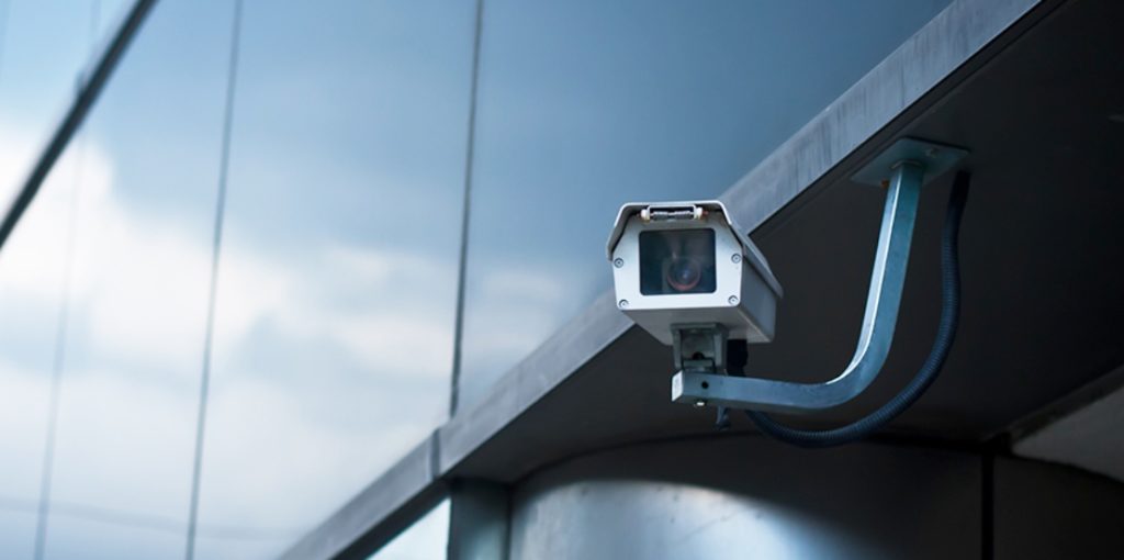 One CCTV camera placed on a modern office building.